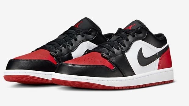 Side view of red and black Air Jordan sneakers.